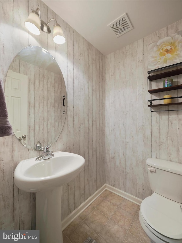 1161 Steed St, Ranson, WV 25438 - half bathroom featuring baseboards, toilet, and wooden walls