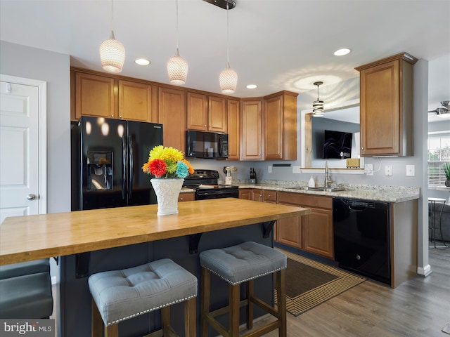 1161 Steed St, Ranson, WV 25438 - kitchen with black appliances, wood counters, a sink, recessed lighting, and wood finished floors
