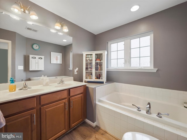 1161 Steed St, Ranson, WV 25438 - full bathroom featuring wood finished floors, a garden tub, and double vanity