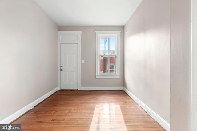 empty room featuring light wood-style floors and baseboards