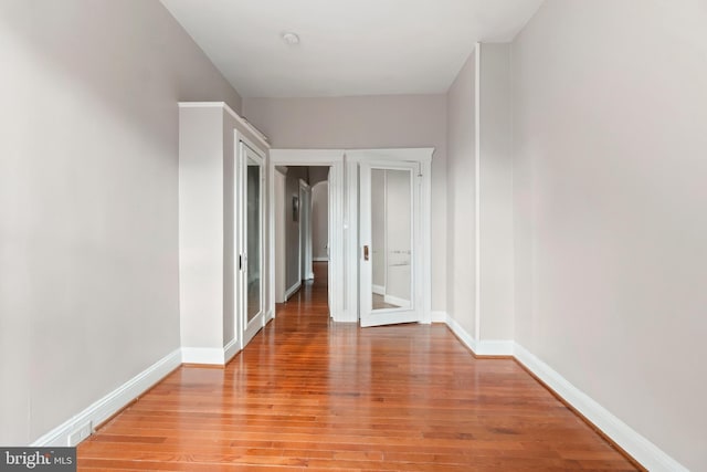 hallway with baseboards and light wood finished floors