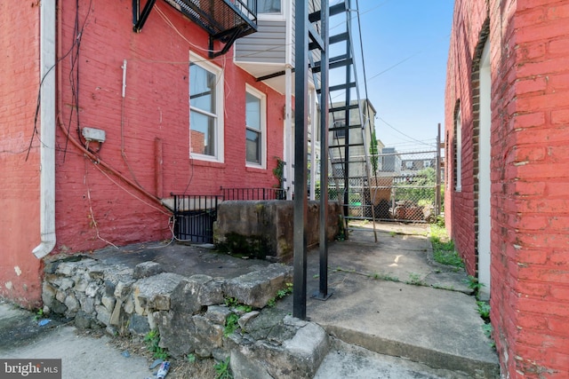 view of side of home featuring fence