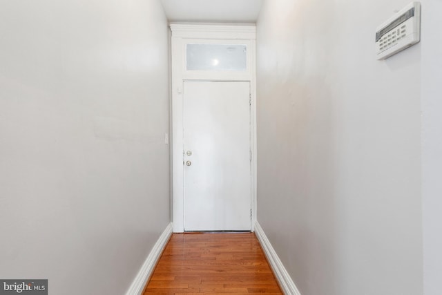 entryway featuring baseboards and wood finished floors