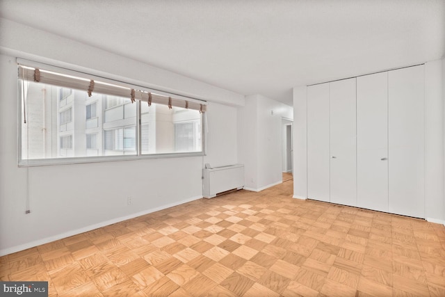 unfurnished bedroom featuring baseboards and a closet