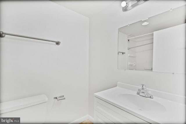 bathroom featuring vanity and toilet