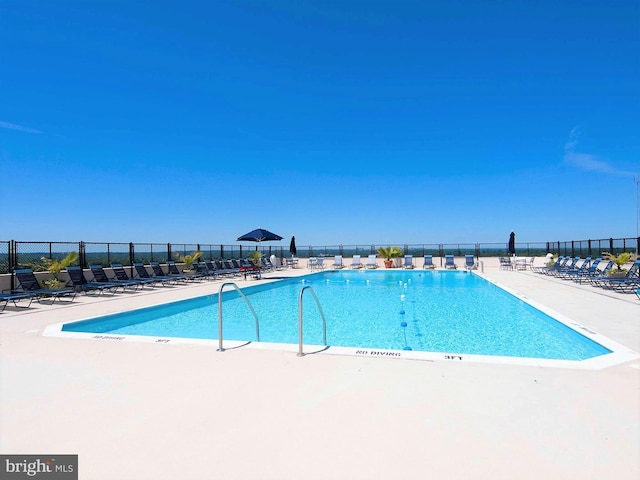 pool featuring a patio and fence
