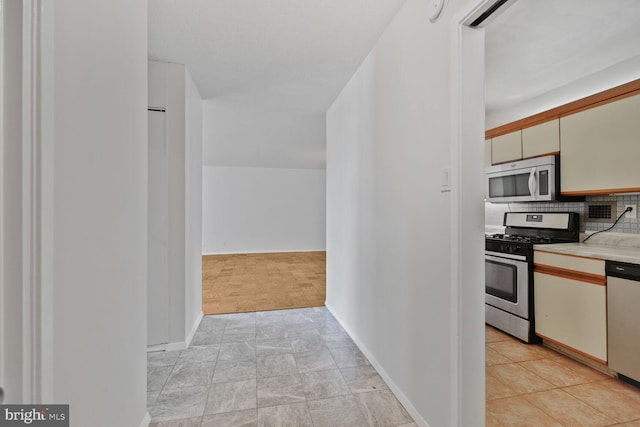 hall featuring baseboards and stone finish flooring