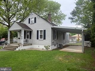 back of property with a lawn and a chimney