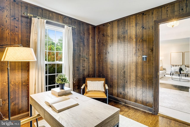 office with wood walls, wood finished floors, and baseboards