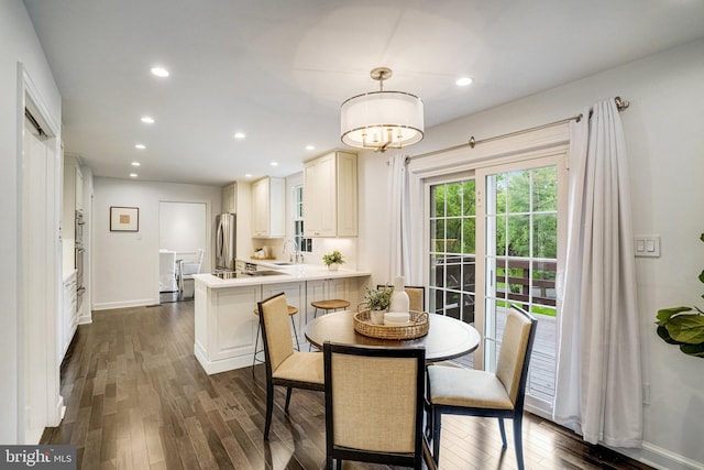 dining space featuring dark wood finished floors, recessed lighting, and baseboards