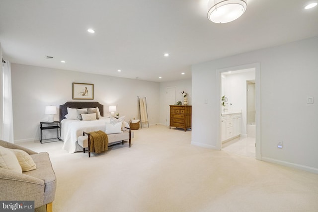 bedroom with light colored carpet, recessed lighting, ensuite bathroom, and baseboards