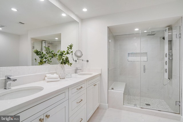 bathroom with recessed lighting, a stall shower, and double vanity