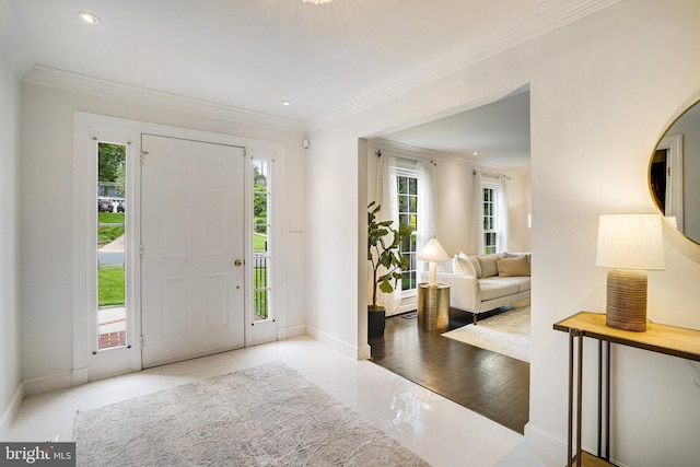 foyer entrance featuring ornamental molding, baseboards, and recessed lighting