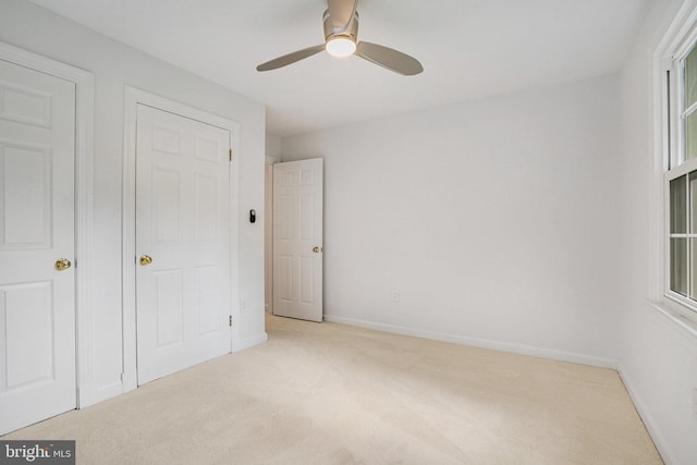 unfurnished bedroom with carpet flooring, baseboards, and ceiling fan