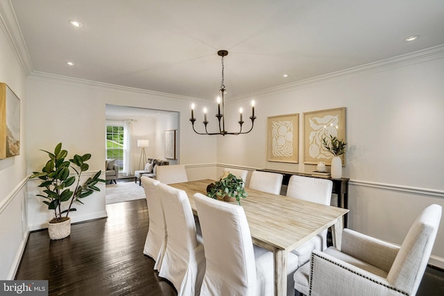 dining area with crown molding, dark wood-style flooring, a chandelier, baseboards, and recessed lighting