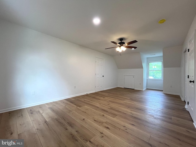 bonus room with baseboards, ceiling fan, wood-type flooring, and vaulted ceiling