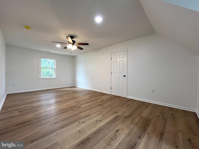 bonus room featuring wood-type flooring, ceiling fan, vaulted ceiling, and baseboards