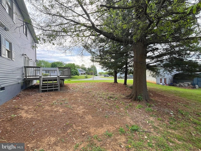 view of yard featuring a wooden deck