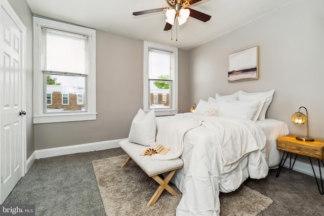 carpeted bedroom with a ceiling fan and baseboards