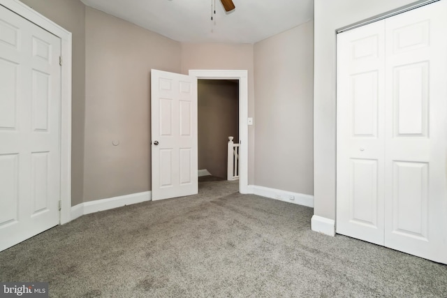 unfurnished bedroom featuring carpet flooring, baseboards, ceiling fan, and a closet