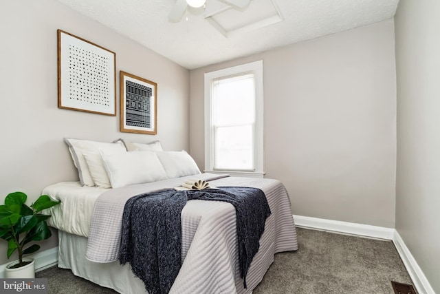 carpeted bedroom with baseboards, attic access, a ceiling fan, and visible vents