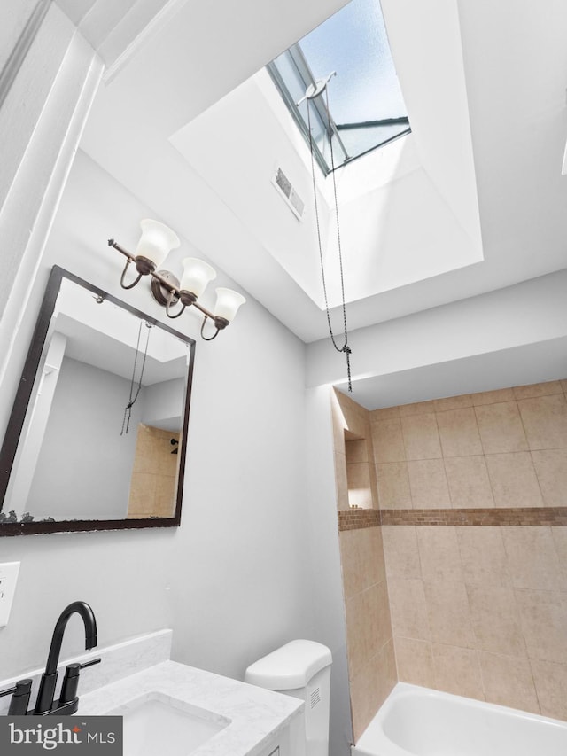 bathroom with visible vents,  shower combination, toilet, and vanity