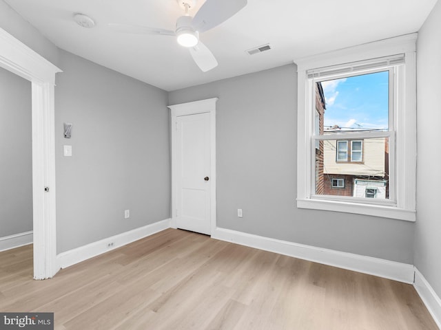unfurnished bedroom with visible vents, light wood finished floors, and multiple windows