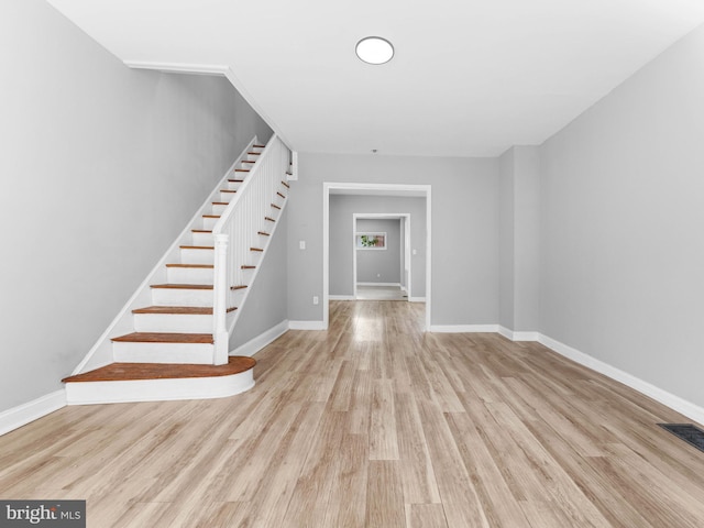 interior space featuring baseboards, visible vents, and wood finished floors