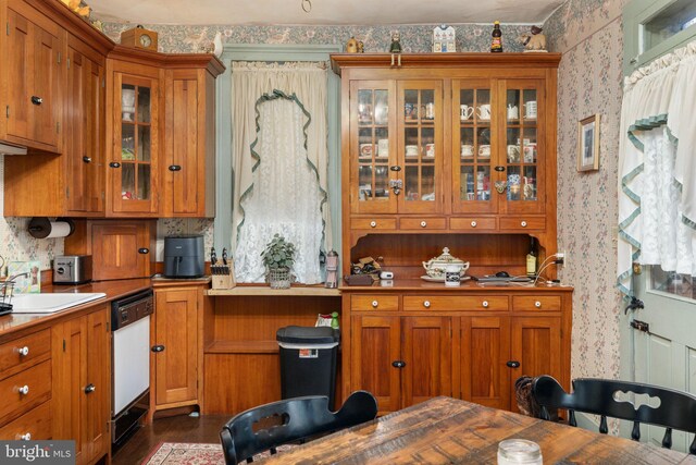 kitchen featuring a sink, wallpapered walls, and dishwasher