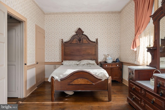bedroom featuring wallpapered walls and dark wood-style floors