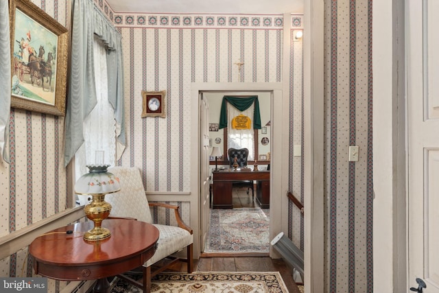 hallway featuring wallpapered walls and wood finished floors