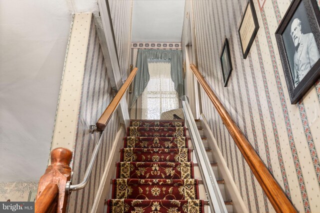 stairway with wallpapered walls