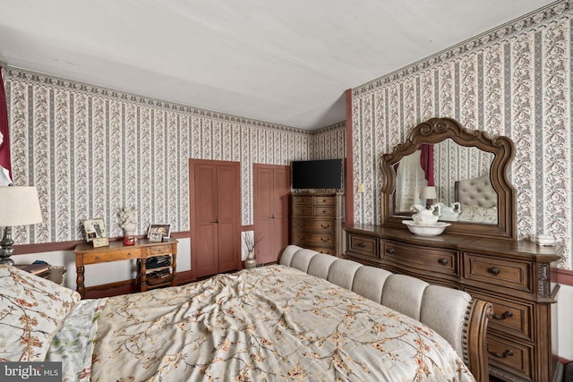 bedroom featuring wallpapered walls