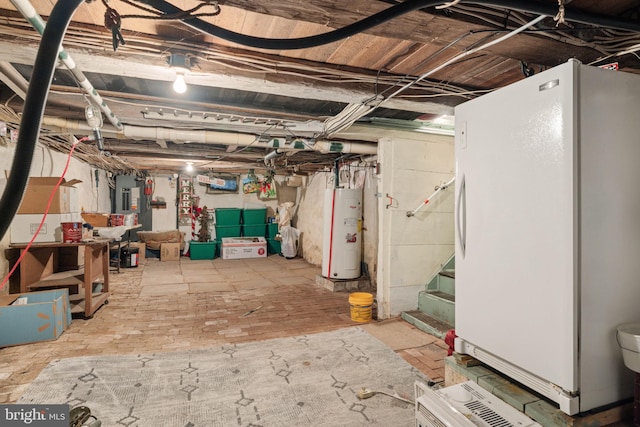 unfinished below grade area featuring freestanding refrigerator, stairs, water heater, and electric panel