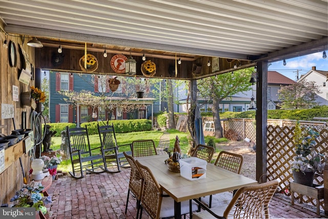view of patio featuring fence and outdoor dining area