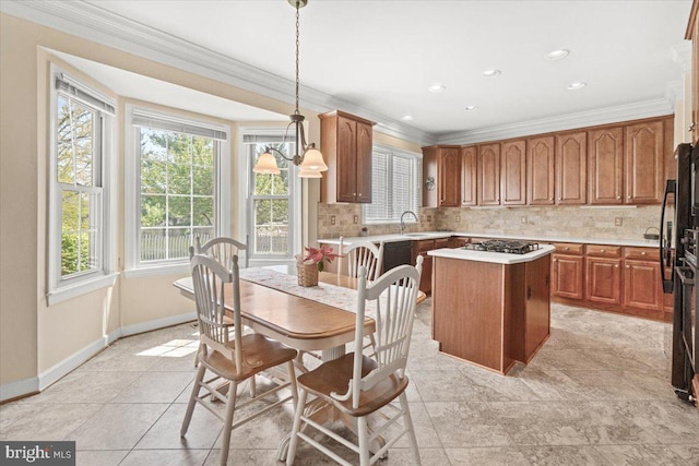 6341 Knollwood Dr, Frederick, MD 21701 - kitchen featuring ornamental molding, a kitchen island, a sink, decorative backsplash, and light countertops