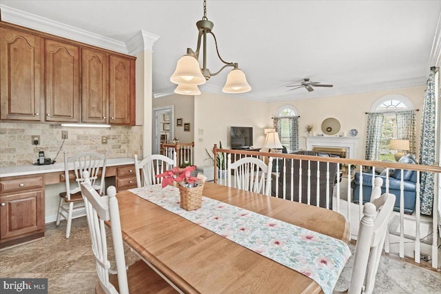 6341 Knollwood Dr, Frederick, MD 21701 - dining room featuring crown molding, a ceiling fan, and a fireplace