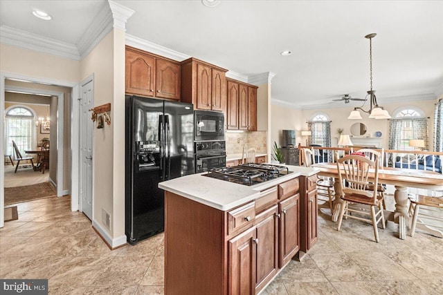 6341 Knollwood Dr, Frederick, MD 21701 - kitchen with black appliances, healthy amount of natural light, a center island, light countertops, and ornamental molding
