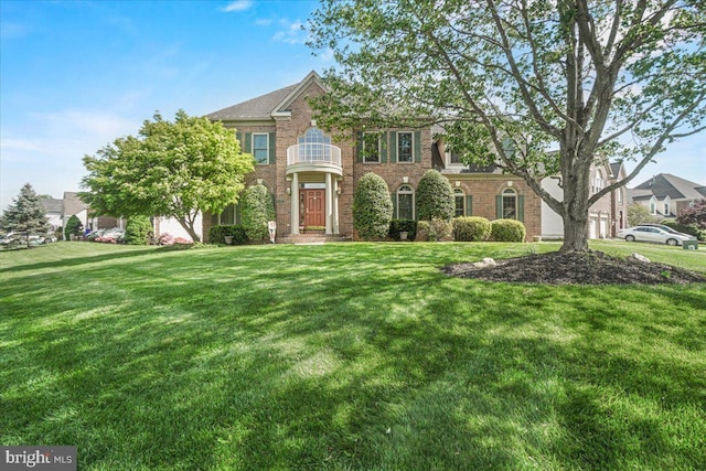 6341 Knollwood Dr, Frederick, MD 21701 - georgian-style home with a front yard and brick siding