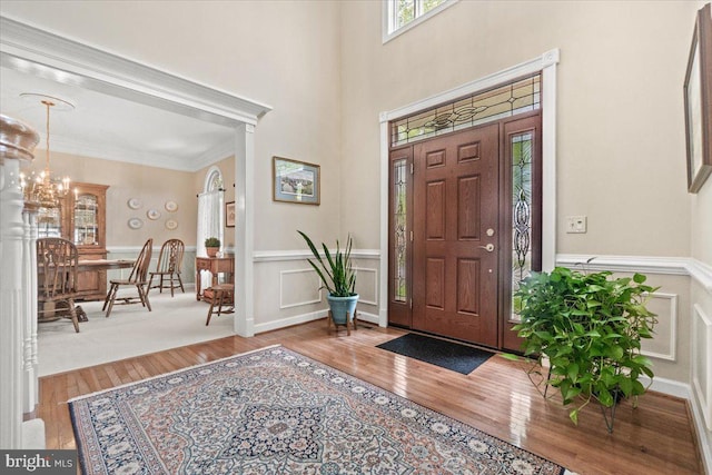 6341 Knollwood Dr, Frederick, MD 21701 - foyer entrance featuring wood finished floors, wainscoting, ornamental molding, a chandelier, and a decorative wall