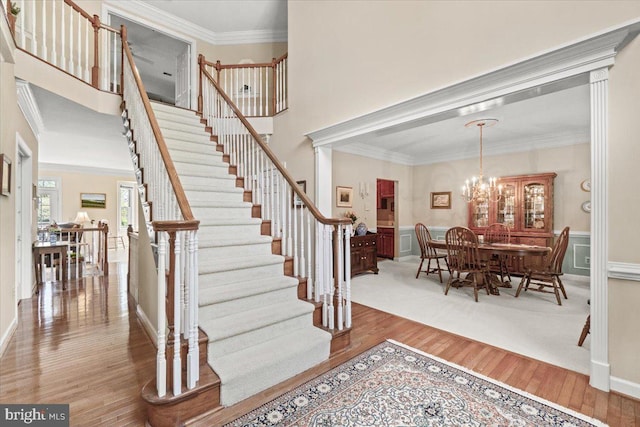 6341 Knollwood Dr, Frederick, MD 21701 - foyer featuring wood finished floors, crown molding, stairway, and a chandelier