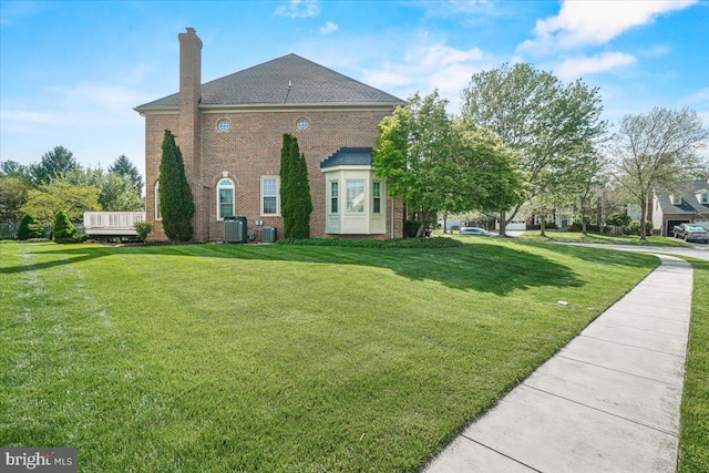6341 Knollwood Dr, Frederick, MD 21701 - view of side of property featuring cooling unit, a lawn, and a chimney