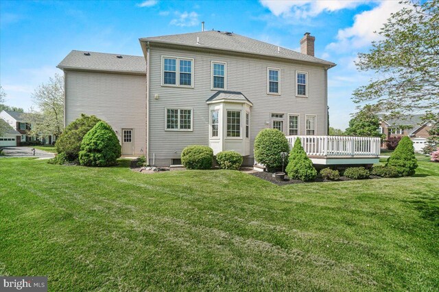 6341 Knollwood Dr, Frederick, MD 21701 - rear view of property with a chimney, a wooden deck, and a yard