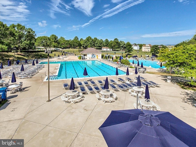 6341 Knollwood Dr, Frederick, MD 21701 - community pool featuring a patio area and view of scattered trees