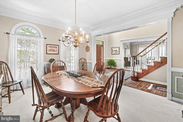 6341 Knollwood Dr, Frederick, MD 21701 - dining area featuring carpet flooring, a chandelier, crown molding, stairs, and a wainscoted wall