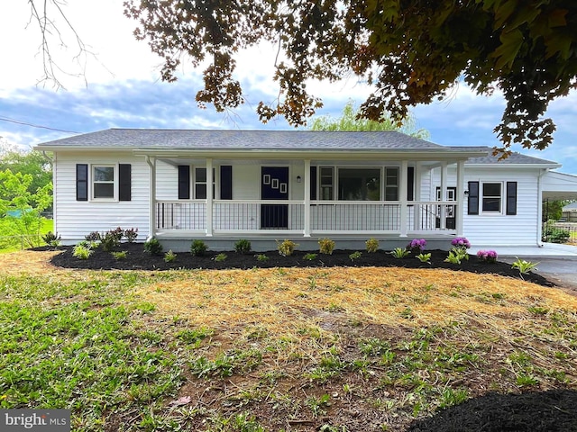 single story home with a porch and a carport