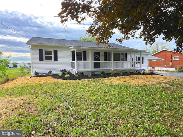 view of front of property with fence, covered porch, and a front yard