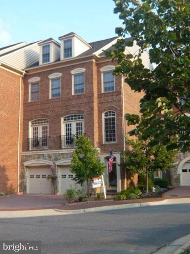 view of front of house with brick siding and a garage