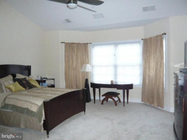 bedroom featuring light carpet, a ceiling fan, and visible vents