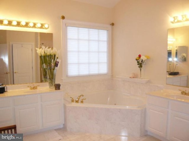 bathroom with a sink, tile patterned floors, a bath, and two vanities